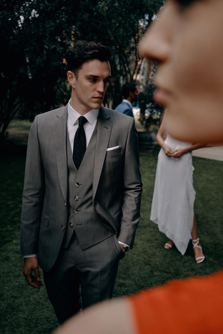 British model Josh Beech wears a dapper gray three-piece BOSS suit.