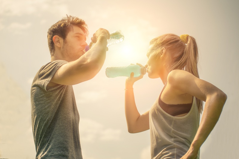 Couple Drinking Water After Workout