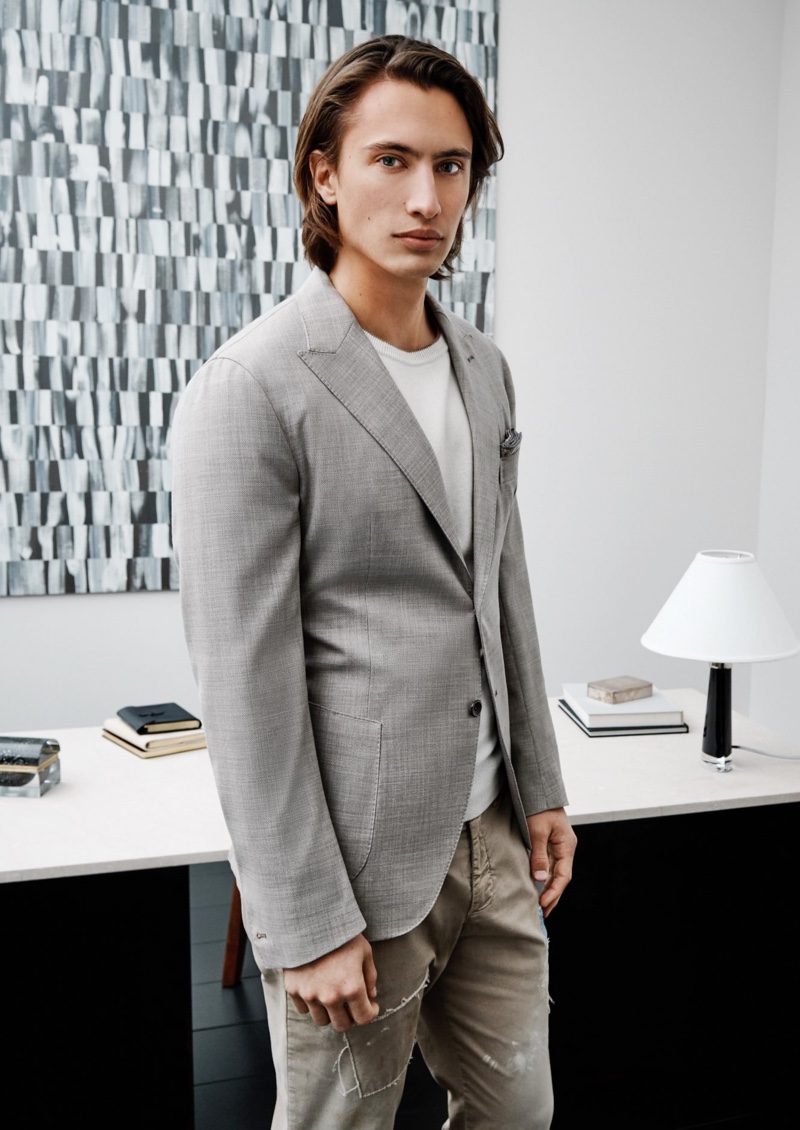 James Turlington dons a linen and wool jacket with a sweater and distressed pants from Eleventy.