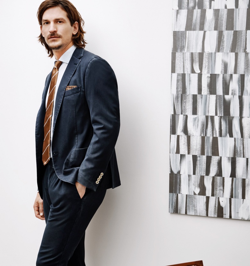 An elegant vision, Jarrod Scott wears a wool suit jacket and pants with a cotton shirt by Eleventy.