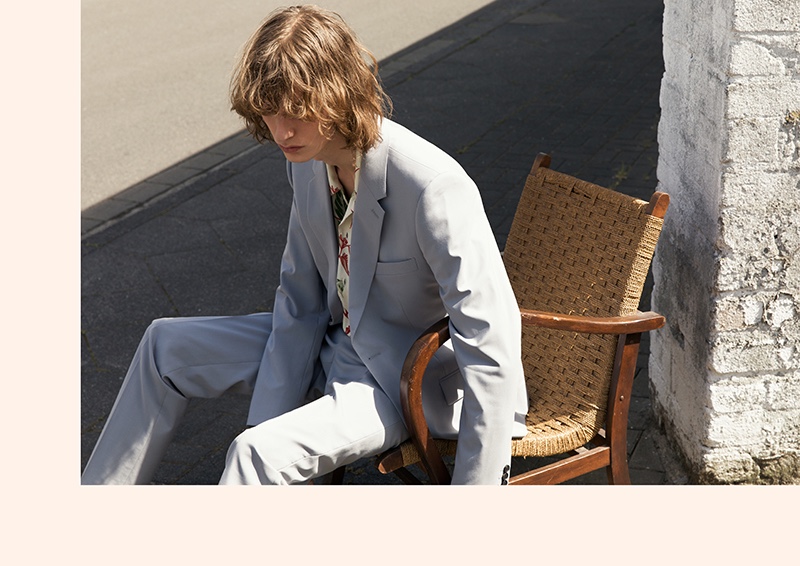 Casper Plantinga models a smart suit with a charming printed shirt by Sandro.