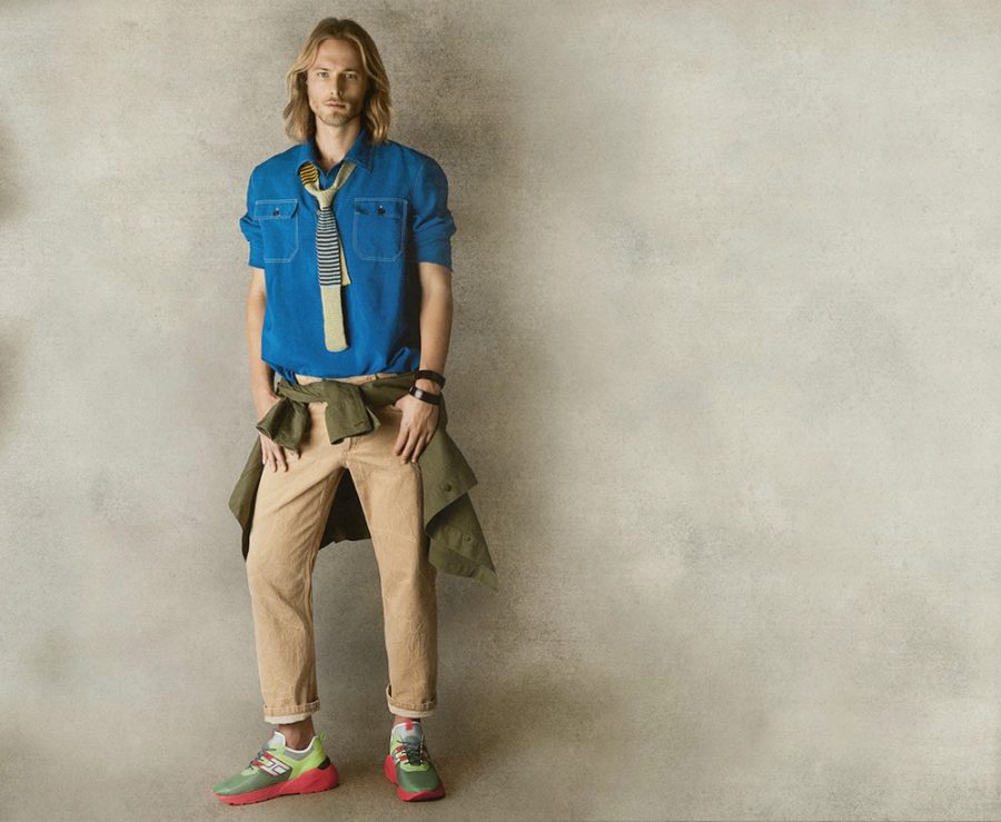 Going preppy, Luke Mählmann adds some color to his outfit of choice with Hogan sneakers.