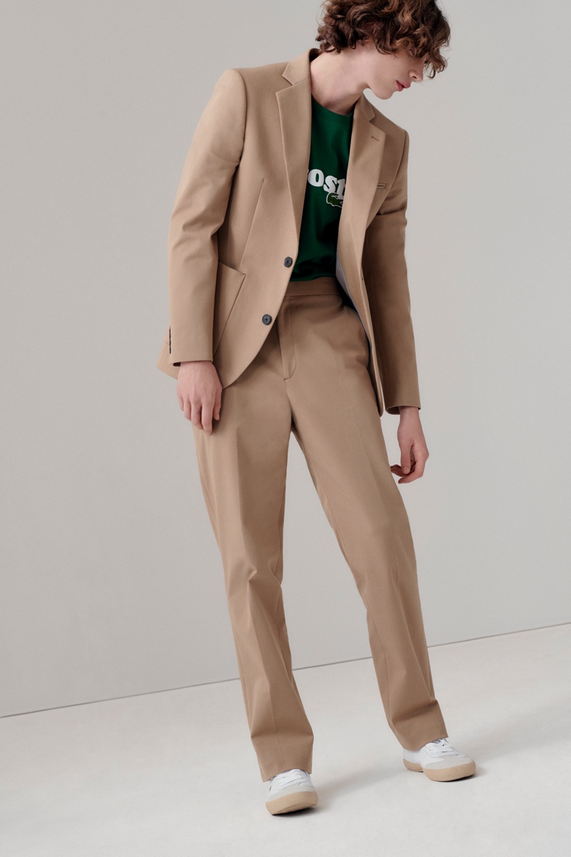 Connecting with Lacoste for fall-winter 2020, Freek Iven wears a khaki suit with a logo tee.