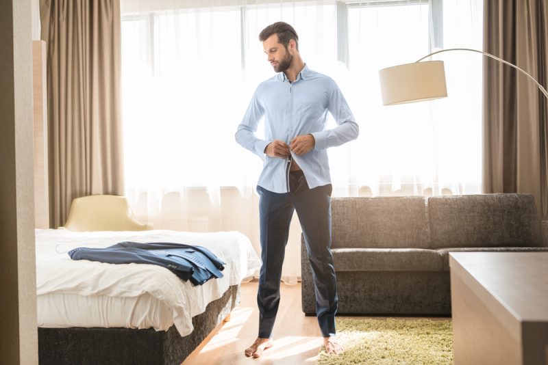 Man Putting on Dress Shirt and Suit » When to Wear a Dress Shirt Man Putting on Dress Shirt and Suit