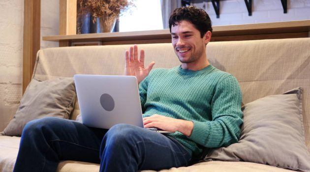 Fashion Trends to Impress Your Online Date Man Smiling Webcam Colorful Sweater
