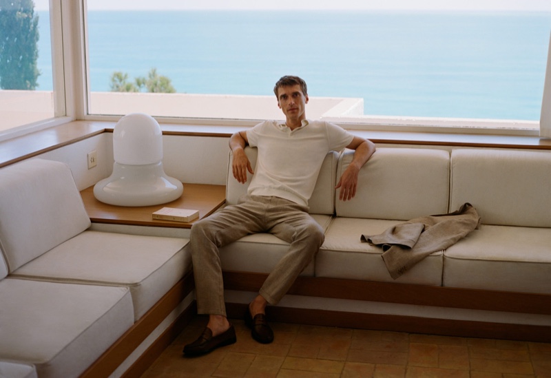 Relaxing, Clément Chabernaud wears a knit cotton polo shirt with linen houndstooth pants from Mango.
