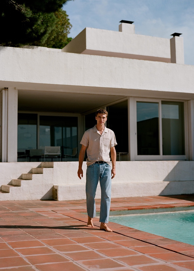 French model Clément Chabernaud dons a Mango linen shirt with tapered fit light wash jeans.