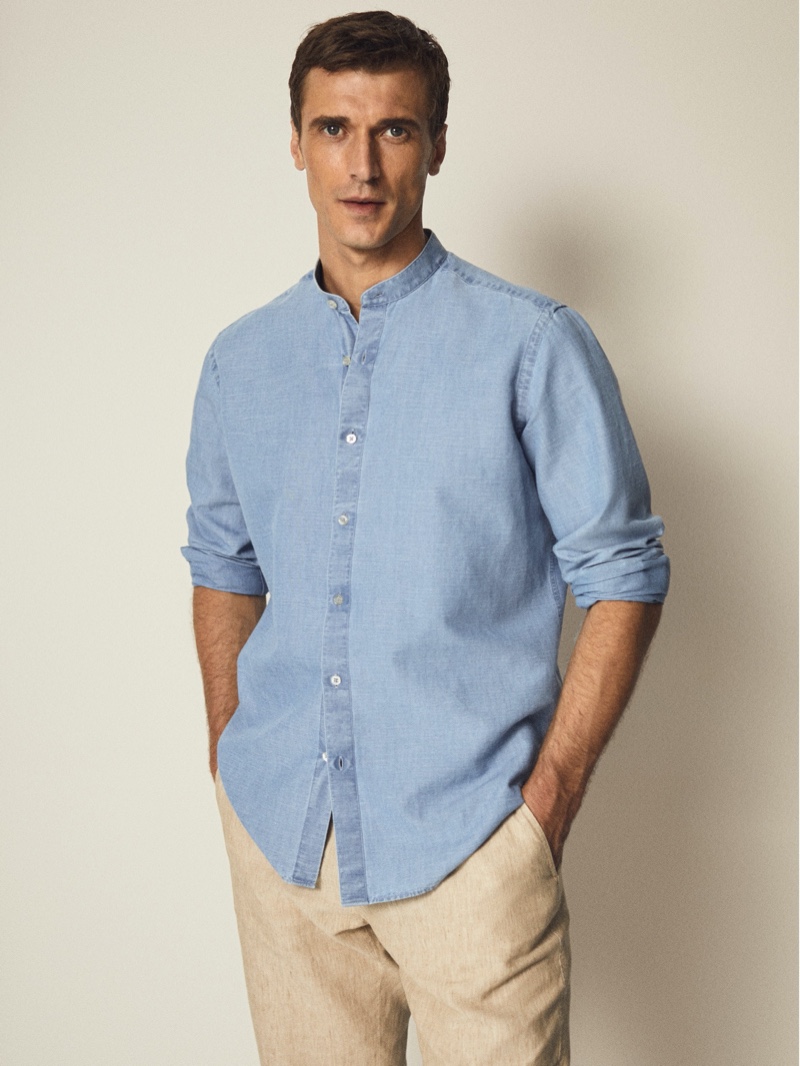 Top model Clément Chabernaud wears a slim-fit denim cotton linen shirt with pants from Massimo Dutti.