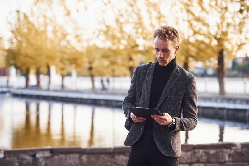 Stylish Man Outside with Notebook