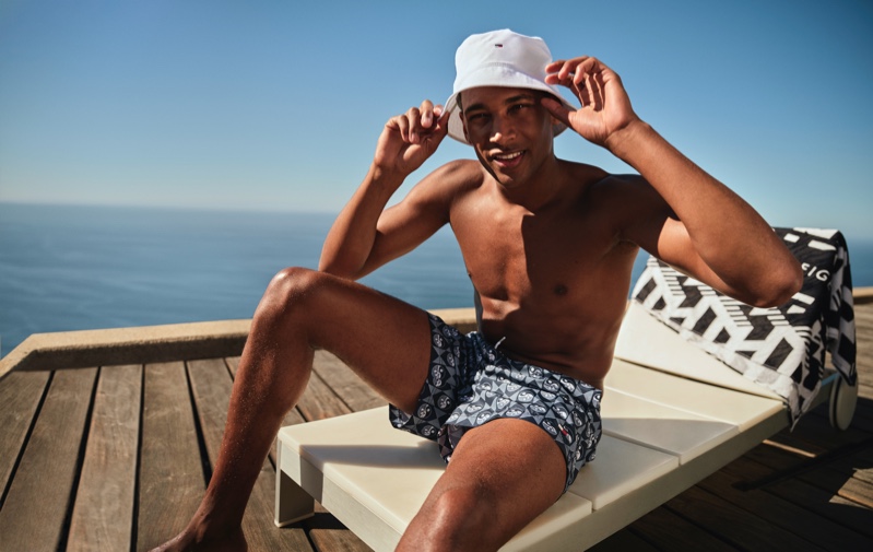 Soaking in the summer sun, Patrick Nodanche models Tommy Hilfiger swimwear.