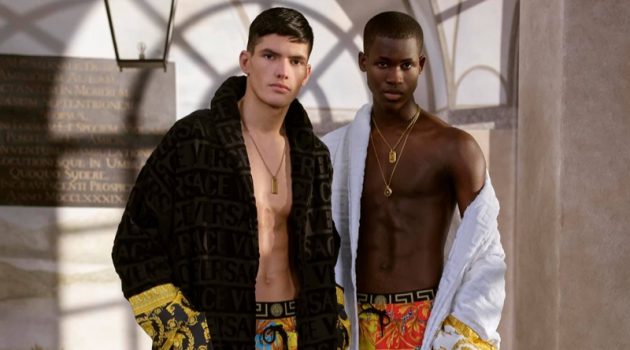 Versace Launches Summer Capsule Collection Models Islam Dulatov and Ismael Savane sport custom robes with swimwear from Versace's summer capsule collection.