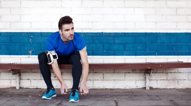 6 Essential Sneaker Styles Every Man Should Own Attractive Man Tying Blue Sneakers Athlete Workout