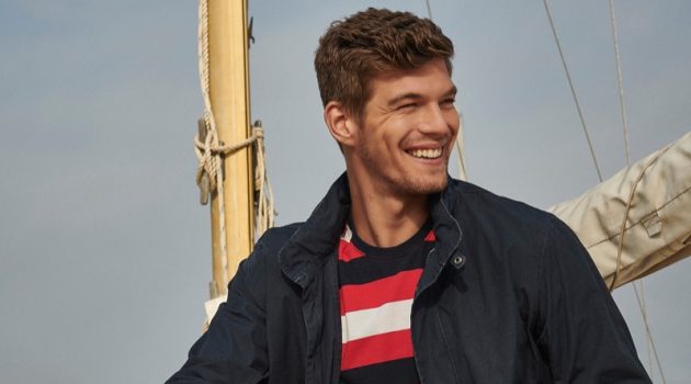 Bertold Hits the Beach in Barbour Coastal Collection Embracing nautical style, Bertold Zahoran wears a striped t-shirt, casual jacket, and chinos from Barbour.