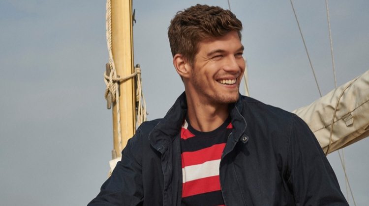 Embracing nautical style, Bertold Zahoran wears a striped t-shirt, casual jacket, and chinos from Barbour.