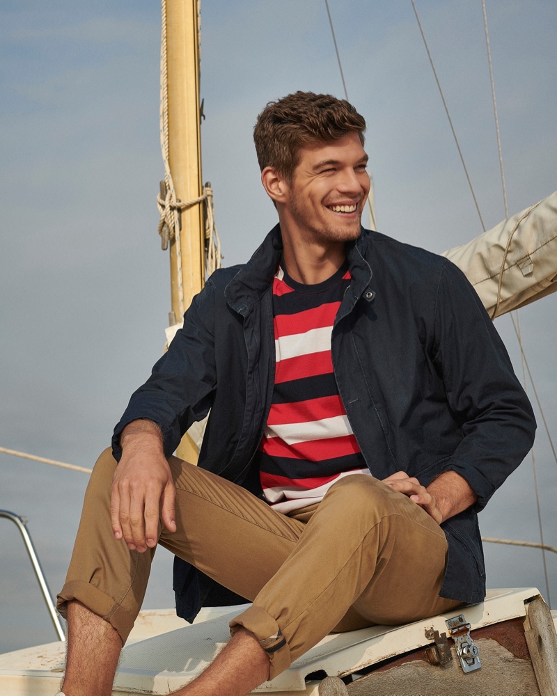 Embracing nautical style, Bertold Zahoran wears a striped t-shirt, casual jacket, and chinos from Barbour.