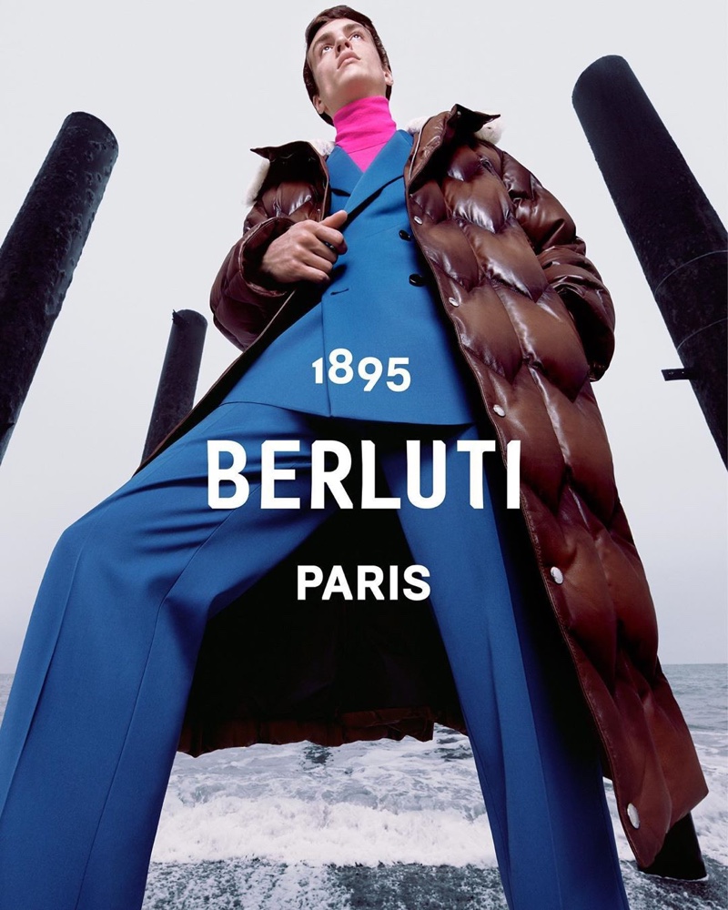 Tobias Dionisi models a double-breasted blue suit with a puffer jacket for Berluti's fall-winter 2020 campaign.