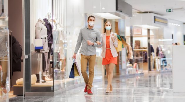 How Clothing Stores Are Implementing Safer Social Distancing Couple Shopping at Mall with Masks