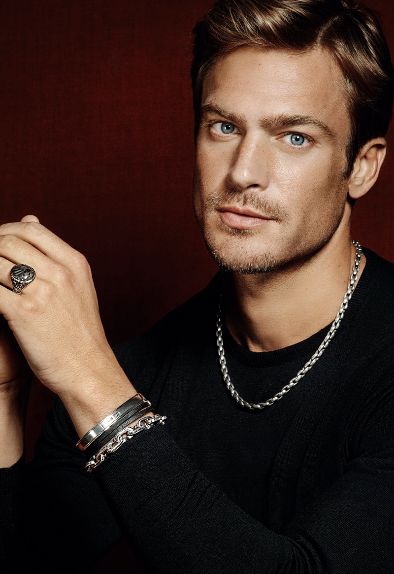 Jason Morgan wears an elongated box chain silver necklace with a streamline chain link silver bracelet from David Yurman. Connecting with Holt Renfrew for the season, he also sports David Yurman's streamline double-wrap leather bracelet and silver bracelet with a Petrvs scarab silver signet ring.