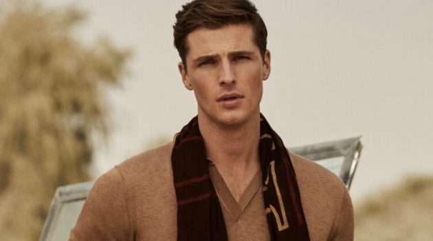 Edward Dons Safari-Inspired Style for Pedro del Hierro Edward Wilding models a short-sleeve tricot polo shirt with Pima cotton chinos and a printed logo scarf from Pedro del Hierro.