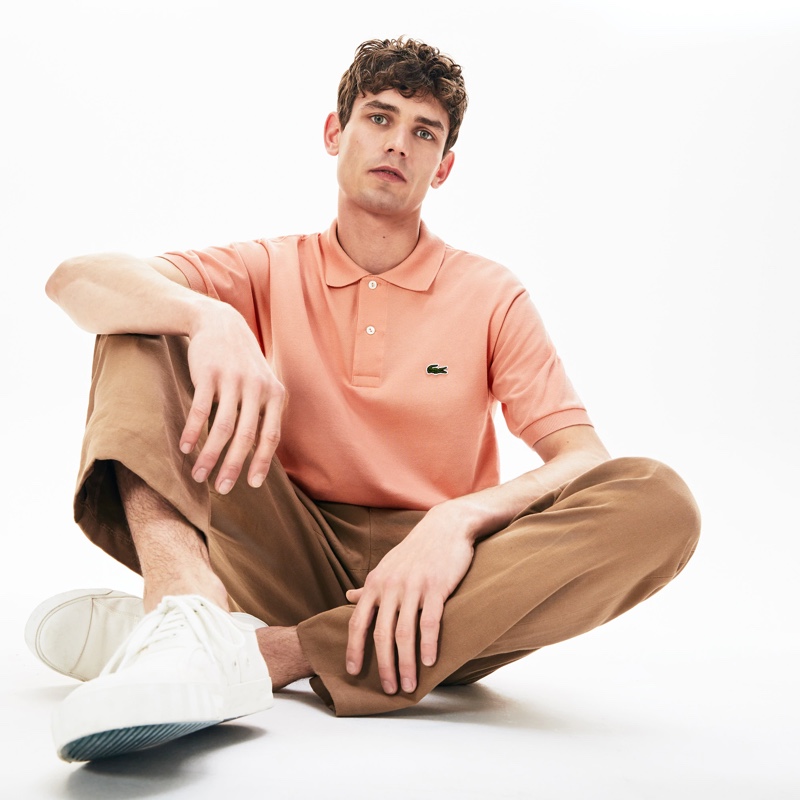 Arthur Gosse models Lacoste's L.12.12 polo in pink.