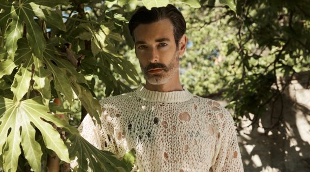 Luca Larenza Tackles an Italian Holiday with Spring '21 Collection Richard Biedul dons a short-sleeve deconstructed sweater with pleated trousers from Luca Larenza's spring-summer 2021 collection.