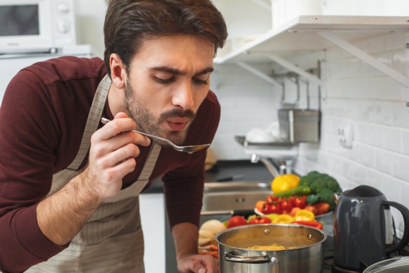 Man Cooking and Tasting