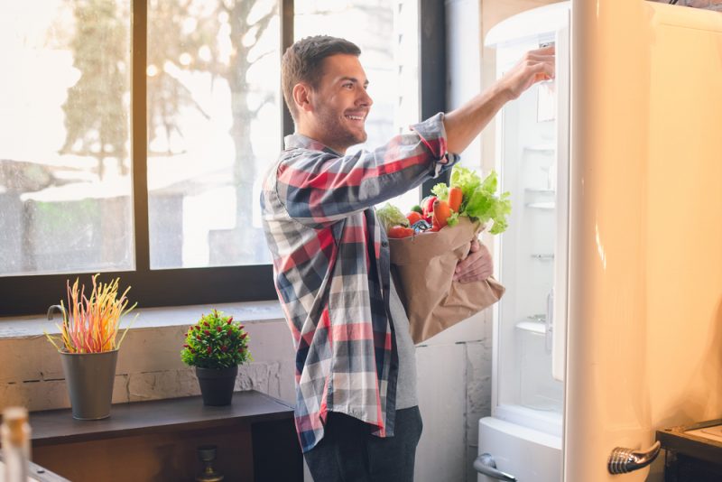 Man Putting Away Groceries