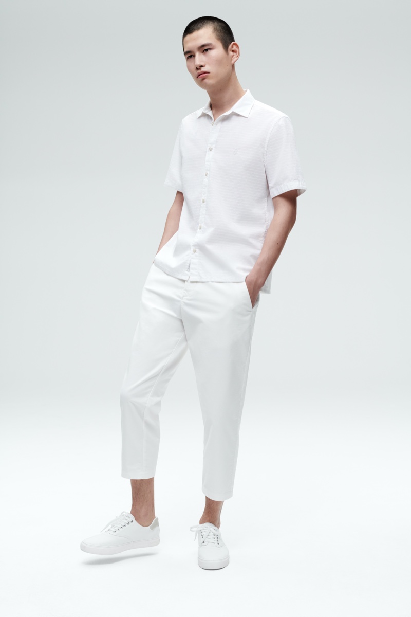 Front and center, Kohei Takabatake models a short-sleeve shirt and cropped trousers from Marc O'Polo's summer white capsule collection.