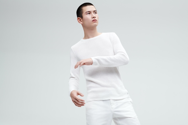 A summer vision, Kohei Takabatake sports a sweater and pants from Marc O'Polo's white capsule collection.