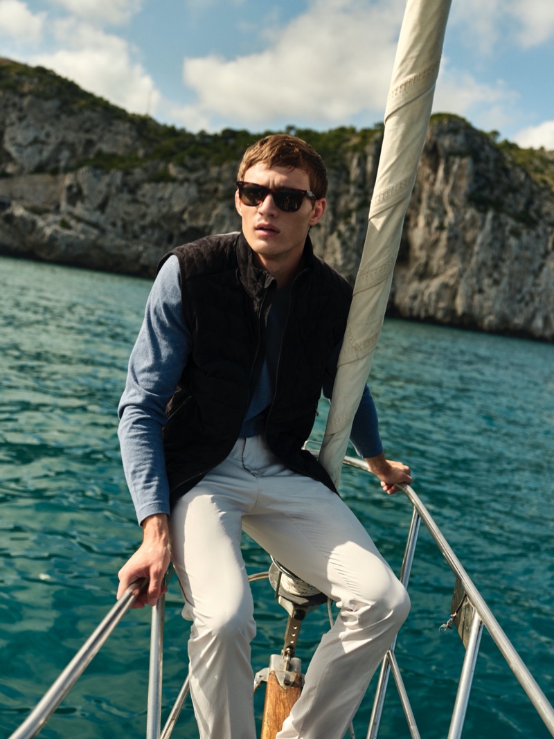 Julian Schneyder heads out to sea in a suede and knit vest with a sweater and chinos from Massimo Dutti.