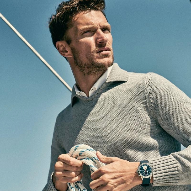 Embracing nautical style, Shaun Dewet wears a grey merino sweater from Orlebar Brown's IWC collection.