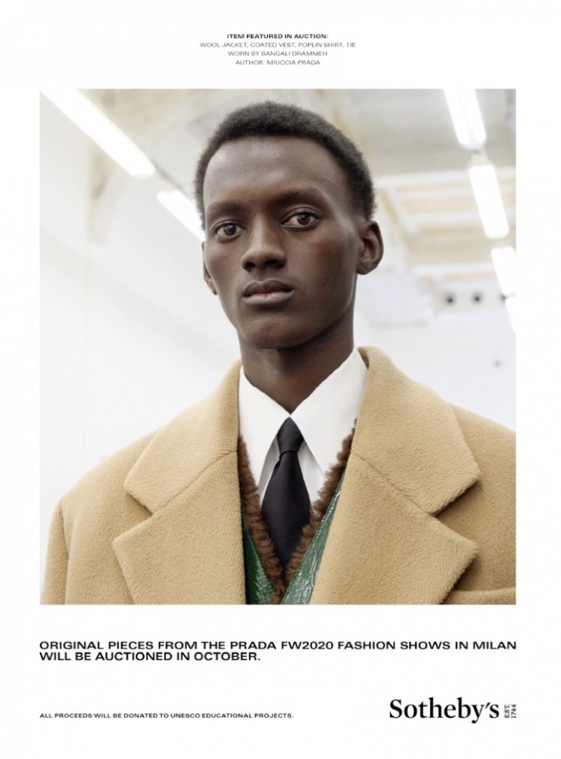 Bangali Drammeh models a wool jacket, vest, shirt, and tie from Prada's fall-winter 2020 collection.