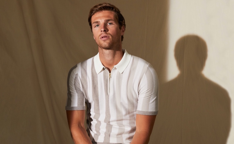 Edward Wilding dons a striped zip neck polo shirt from Reiss.