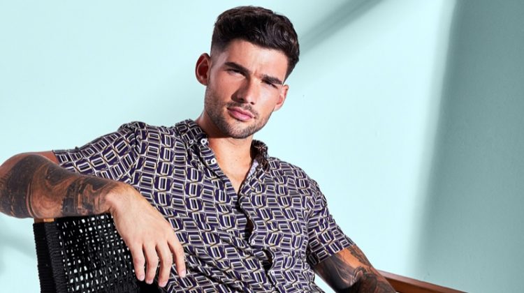 Brandan Stevens sports a short-sleeve printed shirt with ripped jeans from River Island.