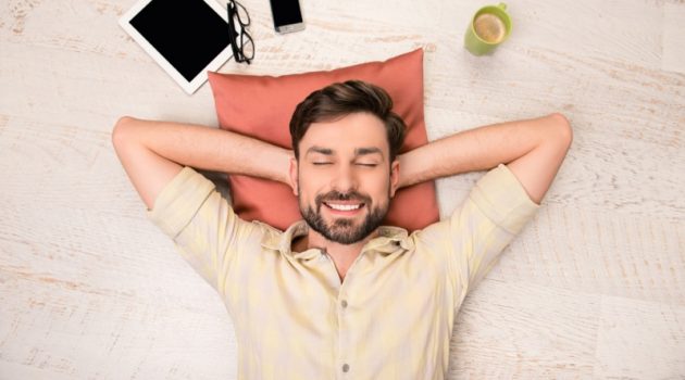 CBD Supplements - Understand What They Are and Their Basic Usage Smiling Man Relaxing Pillow Tablet Phone