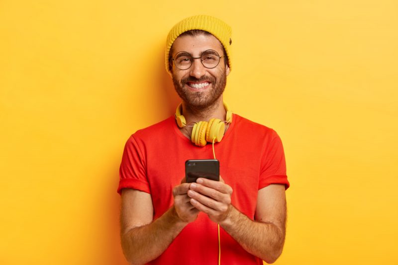 Smiling Man on Phone Wearing Glasses