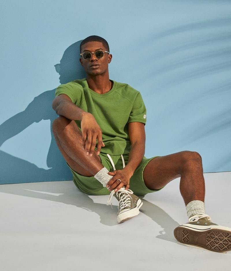 Sporty style takes the spotlight as Yahrock Bates wears a lightweight short-sleeve sweatshirt with warm up shorts from the Todd Snyder + Champion collection.