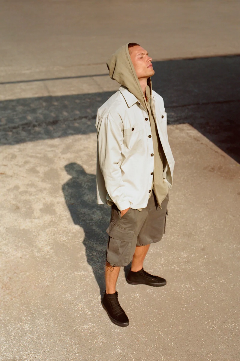 Making a stylish statement, William Los models a hooded shirt from Zara's summer collection.