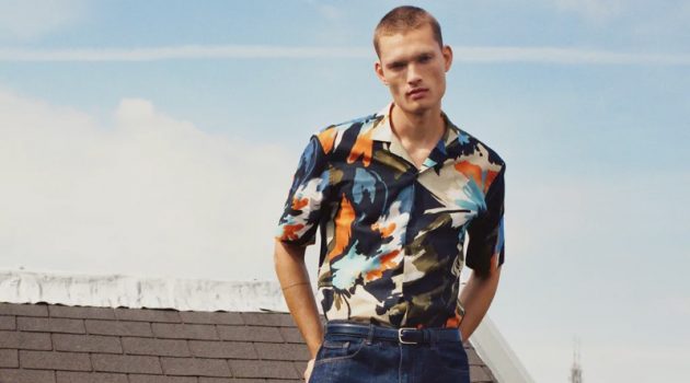 William Tackles Summer Style with Zara Taking to a rooftop in Amsterdam, William Los sports a graphic print short-sleeve shirt with classic blue denim jeans by Zara.