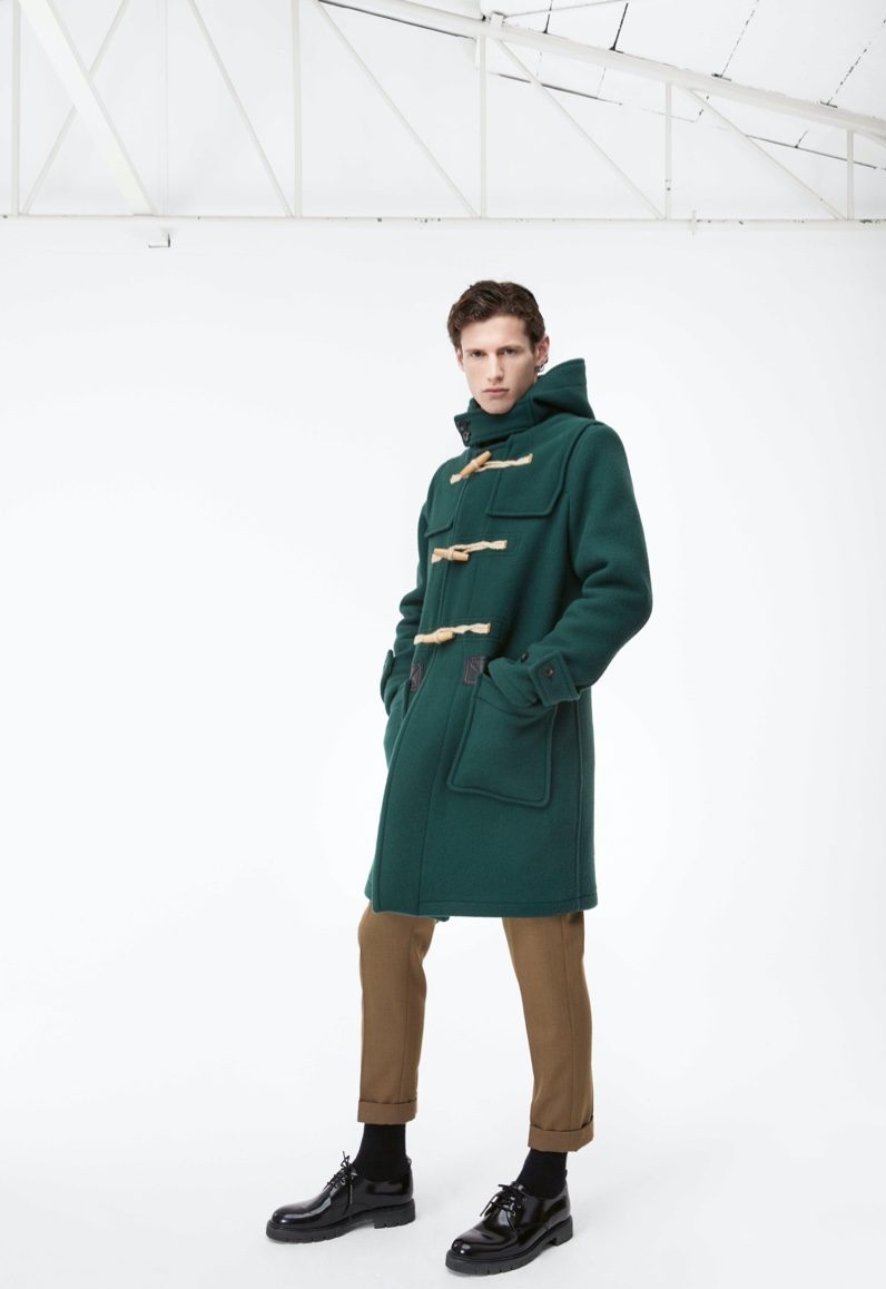 Making a statement in green, Emil dons a Caruso duffle coat and pants for APROPOS Journal.