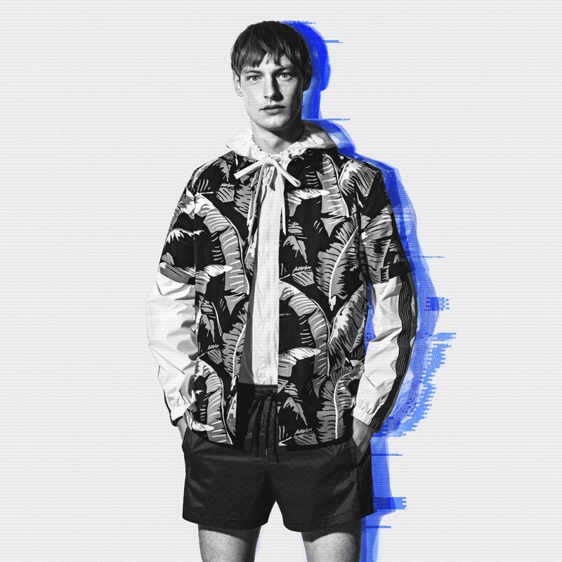 Roberto Sipo sports a printed short-sleeve shirt with a hooded pullover and shorts by Antony Morato.