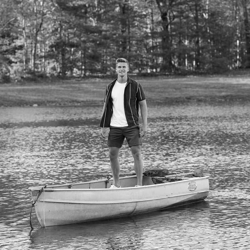 Taking to a canoe, Mitchell Slaggert wears a short-sleeve Banana Republic shirt with a tee and shorts.