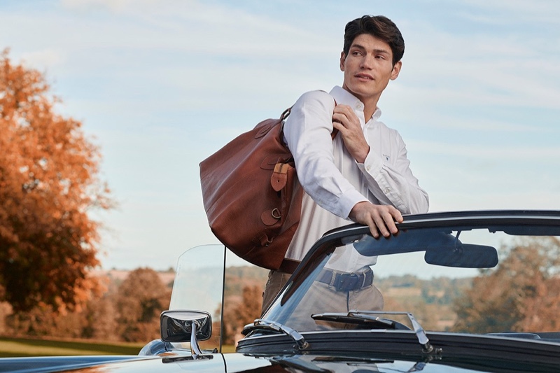 A smart vision, Sam Way dons a white oxford shirt from Barbour.