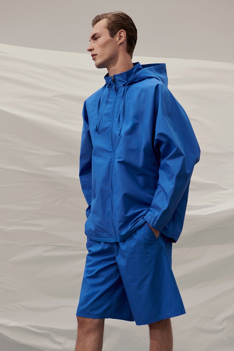 Kit Butler dons a vibrant blue look from COS 'To the Sea' collection.