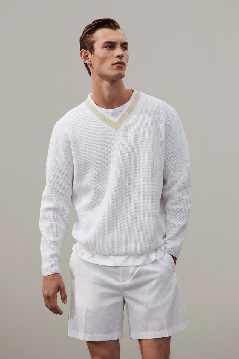 A smart vision in white, Kit Butler models a chic look from COS' 'To the Sea' collection.