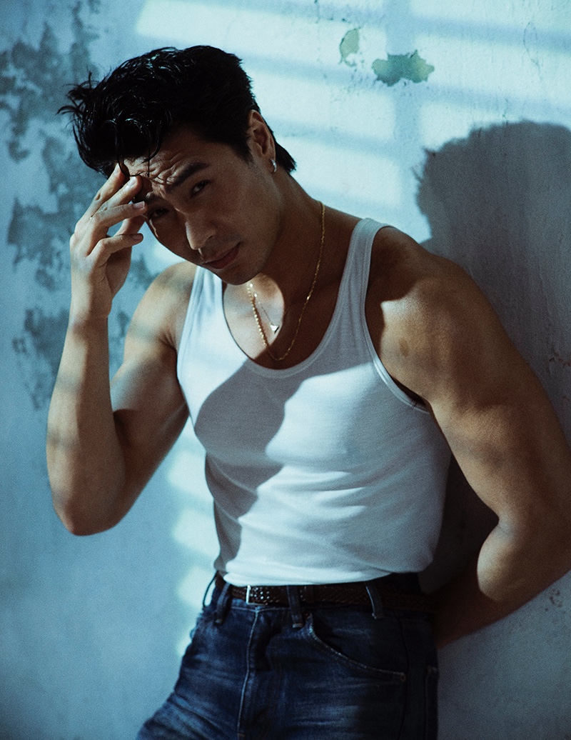 Actor Chris Pang dons a tank, jeans, and leather belt by Celine for Esquire Singapore.