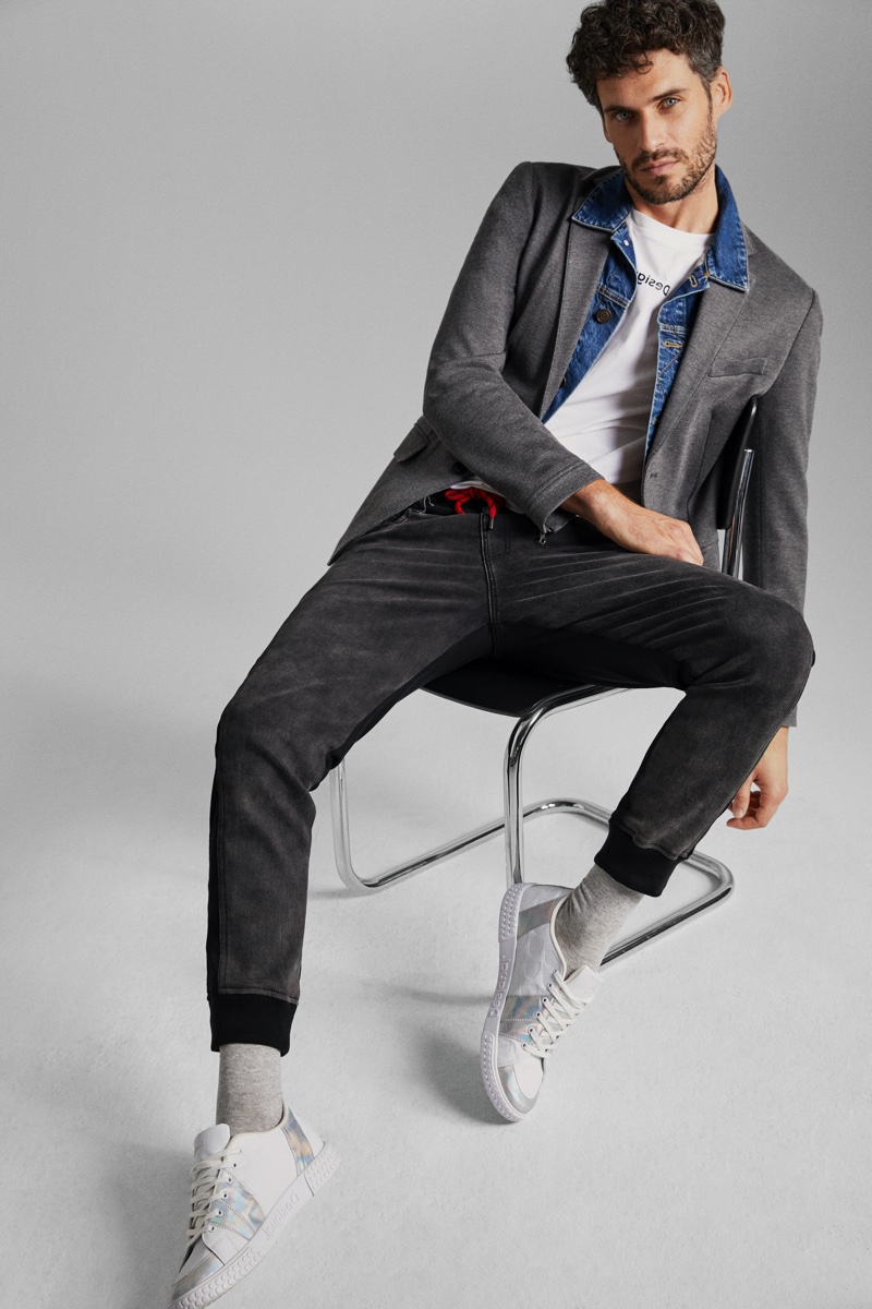 Denim and gray cotton come together as Florent Lahmeri models a look from Desigual's hybrid collection.