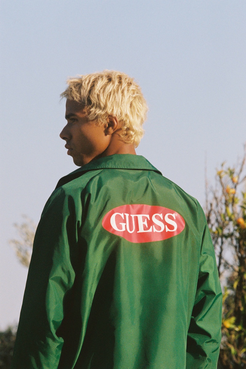 Sporting a coach jacket, Daouda Ka appears in GUESS Originals' fall 2020 campaign.