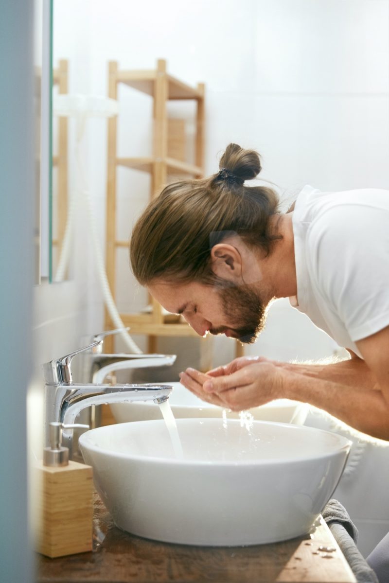 Man with Manbun Washing Face Man with Manbun Washing Face