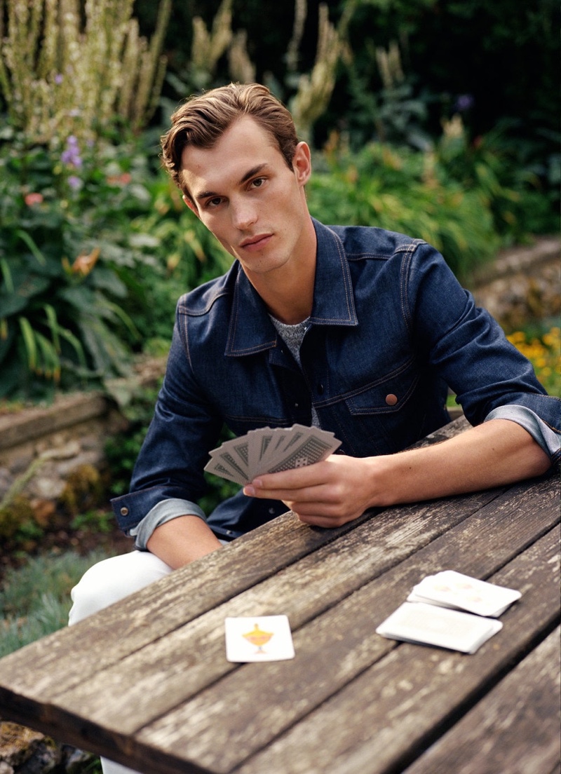 Playing cards, Kit Butler wears a dark wash jean jacket from Mango Man.